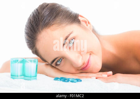 Pretty brunette lying on massage table Stock Photo
