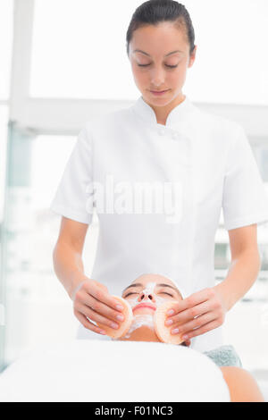Hands cleaning woman woman face with sponge Stock Photo