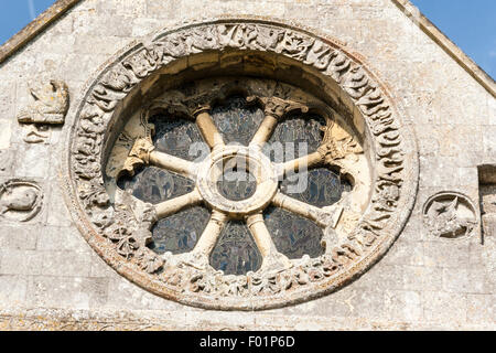 England, Barfrestone. Norman carvings. Church of St Nicholas, 12th century English church, south-east view showing ornate Norman wheel window. Stock Photo