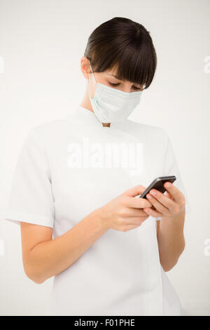Portrait of a nurse using her mobile phone Stock Photo