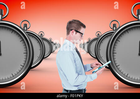 Composite image of handsome businessman using tablet Stock Photo