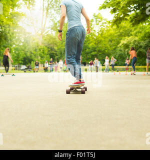 Teenage girl practicing riding long board. Stock Photo