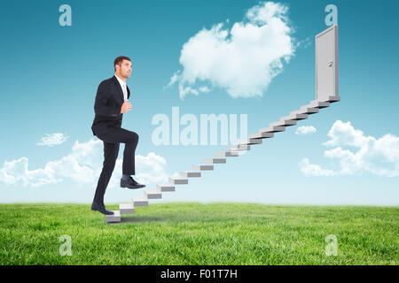 Composite image of businessman walking with his leg up Stock Photo