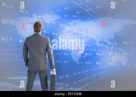 Composite image of businessman standing with his briefcase Stock Photo