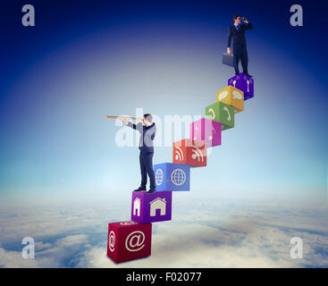 Composite image of businessman using binoculars while holding a briefcase Stock Photo