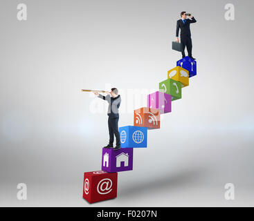 Composite image of businessman using binoculars while holding a briefcase Stock Photo