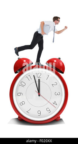 Composite image of geeky businessman running late Stock Photo