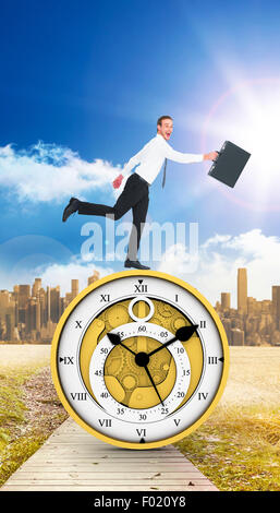 Composite image of happy businessman leaping with his briefcase Stock Photo