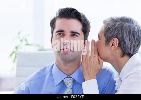 Two business people looking at a paper while working on folder Stock Photo