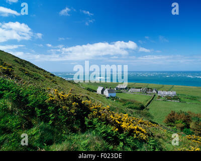 Chapel & mission house, abbey ruins, semi-detached model farmhouses, gardens & stockyards seen from Mynydd Enlli, Bardsey Island, Gwynedd. Stock Photo