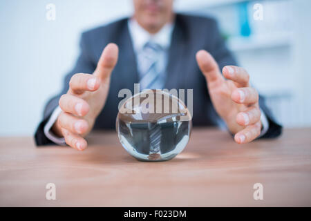 Businessman forecasting a crystal ball Stock Photo