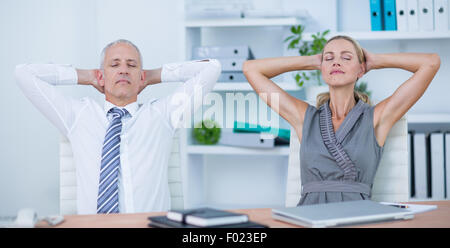 Business people relaxing in swivel chairs Stock Photo