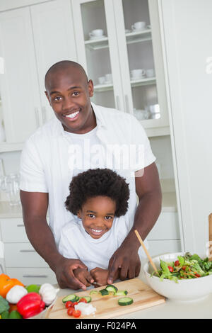 Portrait of happy father and son preparing vegetables Stock Photo