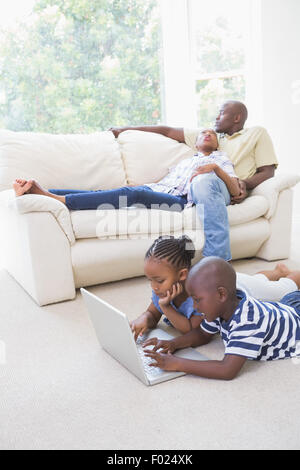 Happy siblings using their laptop Stock Photo