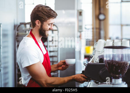 Handsome barista using the coffee machine Stock Photo