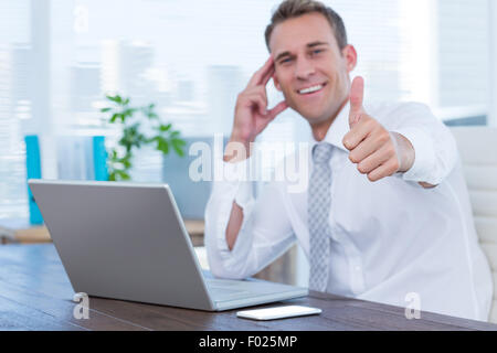 Smiling businessman gesturing thumbs up Stock Photo