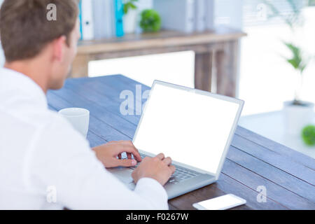 Back view of a businessman typing on laptop Stock Photo