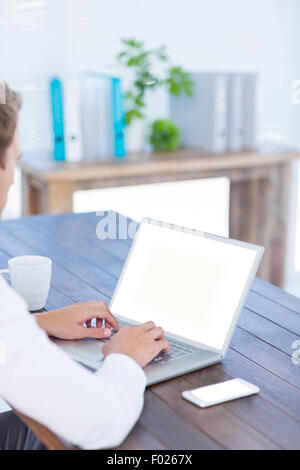Back view of a businessman typing on laptop Stock Photo