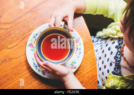 Overhead view of a girl drinking a cup of tea Stock Photo