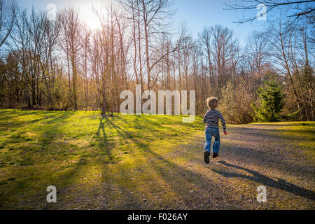 Rear view of a Boy running in countryside Stock Photo