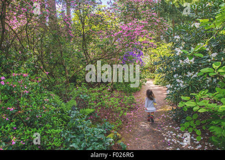 Rear view of a Young girl running along a path Stock Photo