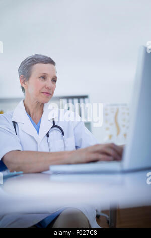 Female doctor using her laptop computer Stock Photo