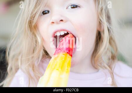 Portrait of a girl eating an ice lolly Stock Photo