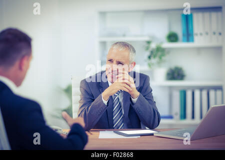 Business colleagues smiling working together Stock Photo