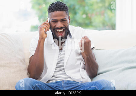 Excited man on the phone Stock Photo