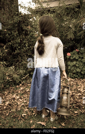 Little girl holding an old paraffin lamp Stock Photo