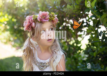 Girl watching a butterfly, California, USA Stock Photo