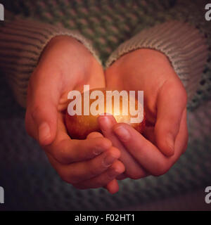 A girl holding golden nest egg in her hands Stock Photo