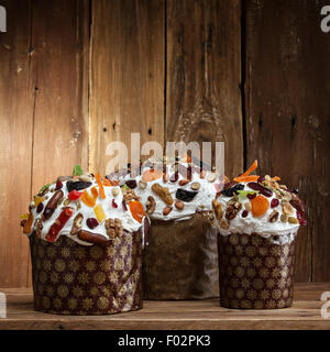 Three delicious freshly baked Easter cakes on a wooden background Stock Photo