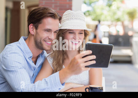 Cute couple looking at a tablet Stock Photo