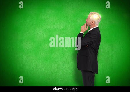 Composite image of thoughtful mature businessman posing Stock Photo