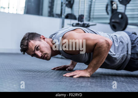 A muscular man doing a pushups Stock Photo