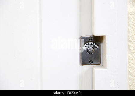 A toilet door engaged lock sign Stock Photo