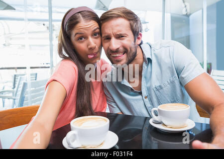 Young couple making selfie with weird faces Stock Photo