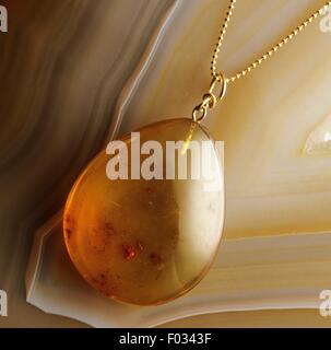 Amber pendant, fossilized tree resin. Stock Photo