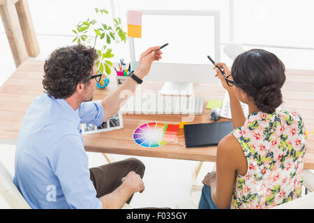 Concentrated coworkers speaking and brainstorming Stock Photo