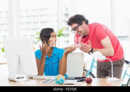 Portrait of cheerful colleagues using computer Stock Photo