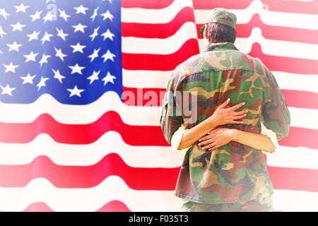 Composite image of army wife reunited with husband Stock Photo