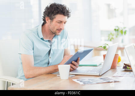 Casual designer using graphics tablet and laptop Stock Photo