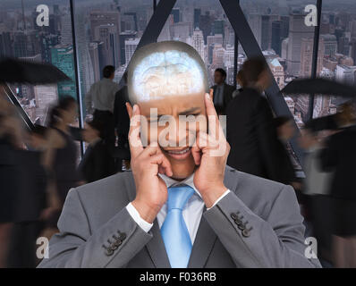 Composite image of stressed businessman putting his fingers on his temples Stock Photo