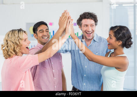 Casual business team high fiving Stock Photo