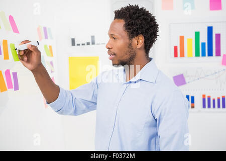Young creative businessman writing on sticky notes Stock Photo