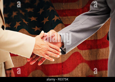 Composite image of close up of business people shaking their hands Stock Photo