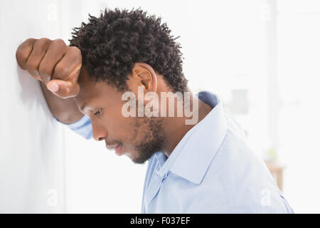 Thoughtful businessman looking down Stock Photo