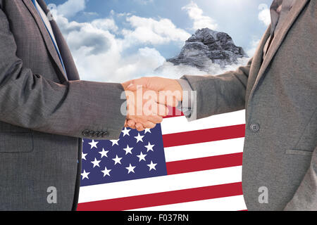 Composite image of close up on two businesspeople shaking hands Stock Photo