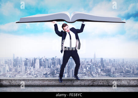 Composite image of businessman in suit lifting up something heavy Stock Photo